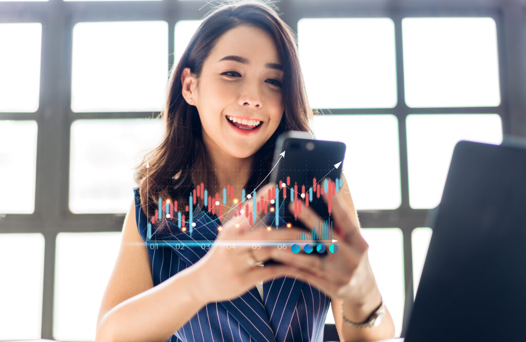 successful business trader investor woman use technology smartphone trading graph block chain stock market cryptocurrency investment selling buy with price chart data graph