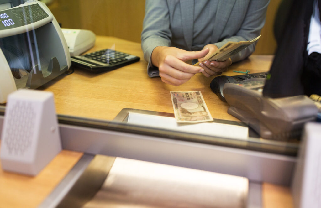 clerk counting cash money at bank office 2023 11 27 05 03 47 utc