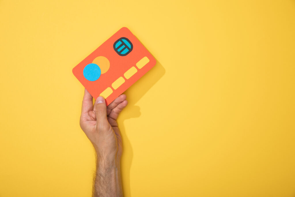 cropped view of man holding red paper credit card 2023 11 27 05 01 31 utc